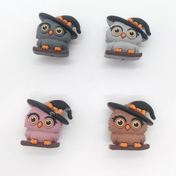 3D witch owl silicone focal bead wearing a black-and-orange witch hat while perched on a branch